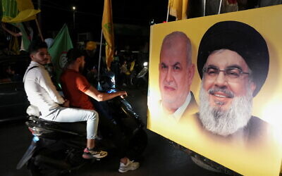 A poster depicting Hezbollah leader Sayyed Hassan Nasrallah and Head of Hezbollah's parliamentary bloc Mohamed Raad in Nabatiyeh, southern Lebanon, on Sunday (Photo: Reuters/Issam Abdallah)
