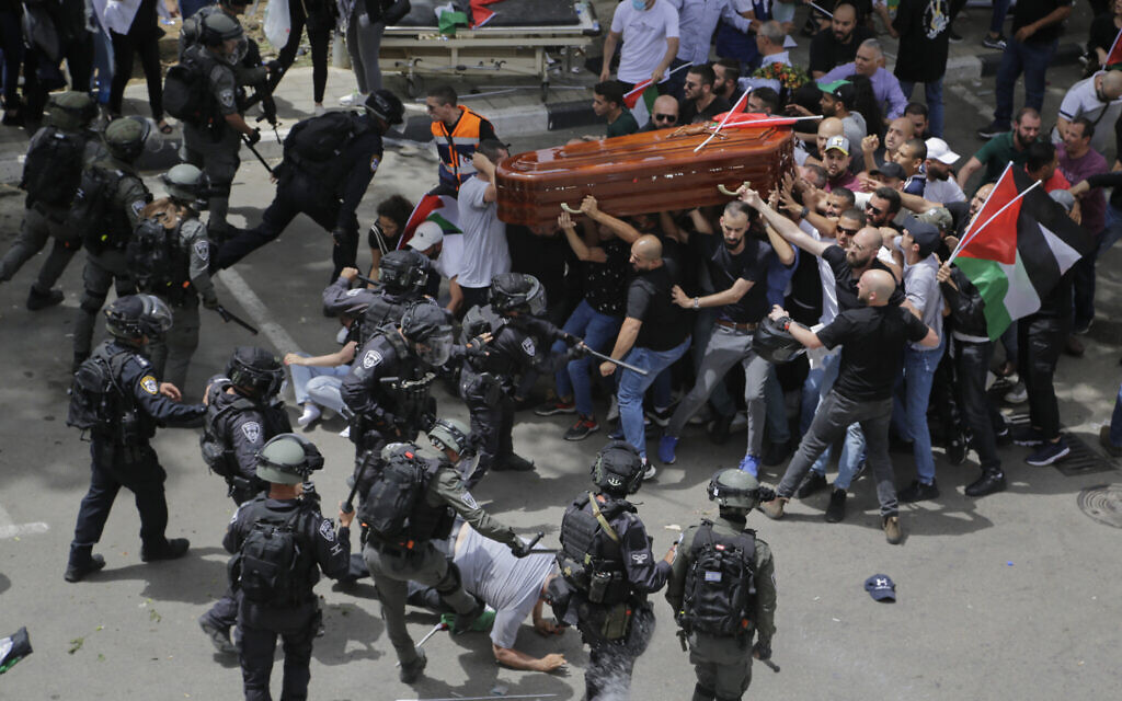 Israeli police confront mourners as they carry the casket of slain Al Jazeera veteran journalist Shireen Abu Akleh during her funeral in east Jerusalem.