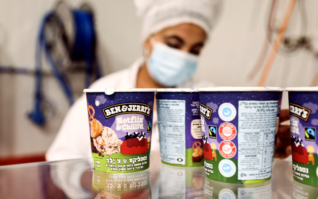 Tubs of ice-cream alongside a labourer working at Ben & Jerry's factory in Be'er Tuvia, Israel (Photo: Reuters/Ronen Zvulun)