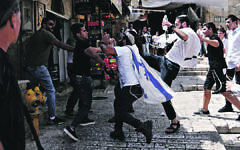 Israeli extremists under the protection of troops assault Palestinians in occupied East Jerusalem ahead of the annual Flag March on 29 May 2022 Israeli extremists under the protection of troops assault Palestinians in occupied East Jerusalem ahead of the annual Flag March on 29 May 2022