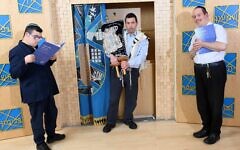 Raphael, Eli and Bezzy with the United Synagogue edition of the inclusive Siddur Sakol