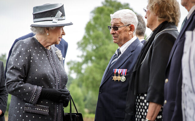 Bernard Levy, wearing his medals, meets the Queen at Bergen Belsen in 2015