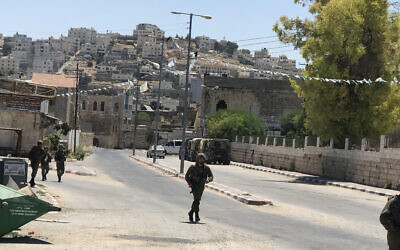 IDF soldiers run towards potential situation in the West Bank city of Hebron, July 2022