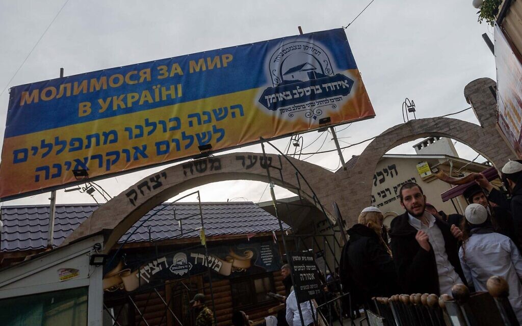 A banner reads “We are praying for peace in Ukraine” near the grave of Rabbi Nachman of Breslov, the site that the pilgrims have to come to see. (David Saveliev)