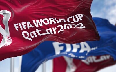 Doha, Qatar, April 2022: Flags with Qatar 2022 World Cup logo and FIFA waving in the wind.