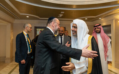 The Chief Rabbi embraces the Secretary General of the World Muslim League at the event. Picture: Fahad Subait.
