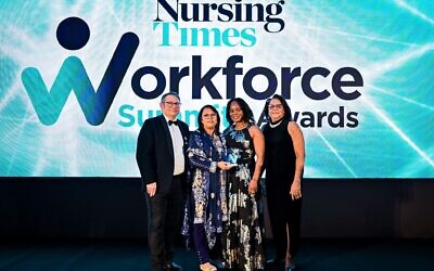Nightingale Hammerson's Roshni Shah, second from left, receiving award from Steve Ford, Nursing Times.