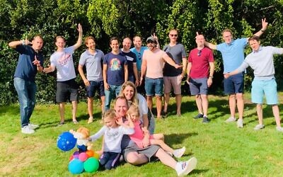 Marc with his wife and children with close friends behind them. This picture was taken on Marc's 40th birthday.