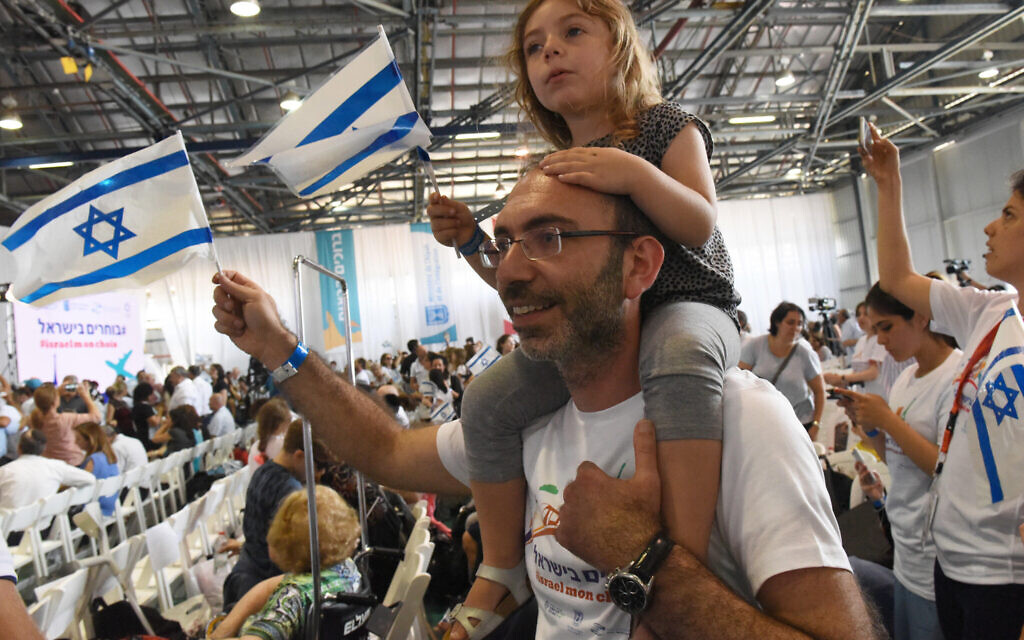 French Jewish immigrants carry Israeli national flag as they arrive from France to Israel at Ben Gurion Airport   Photo by Debbie Hill/ UPI