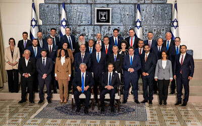 Israeli President Isaac Herzog and newly-elected Prime Minister Benjamin Netanyahu pose for a group photograph with members of the new Israeli government after their swearing-in ceremony, at the president's residence in Jerusalem, December 29, 2022. REUTERS/Oren Ben Hakoon  ISRAEL OUT. NO COMMERCIAL OR EDITORIAL SALES IN ISRAEL.     TPX IMAGES OF THE DAY