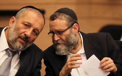 Aryeh Deri (L) the leader of the ultra-Orthodox Shas party, speaks to Moshe Gafni, a parliament member from United Torah Judaism party. REUTERS/Ammar Awad