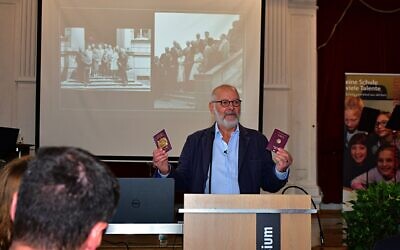 Peter Bradley with his British and German passports, speaking at a school in Germany. Photo: Ulli Koch