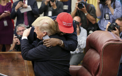 President Donald Trump hugs Kanye West during a meeting in the Oval office of the White House on October 11, 2018 in Washington, DC.  Photo by Oliver Contreras/UPI