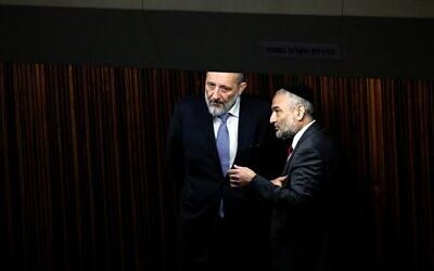 Member of Knesset Aryeh Deri speaks with a member of his party during a session at the plenum at the Knesset, Israel's parliament in Jerusalem December 28, 2022. REUTERS/Ammar Awad