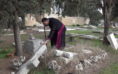 Anglican Archbishop Hosam Naoum inspects vandalized graves on mount Zion outside the old city on January 4, 2023 in Jerusalem, Israel. Security camera video recorded on January 1st. shows two apparently young religious Jews, destroying over 30 graves at the Protestant cemetery of Mount Zion. Christian leaders in Israel have been sounding the alarm about an escalation of radical Jewish groups, that are trying to drive Christians out of Jerusalem. Credit: Eddie Gerald/Alamy Live News