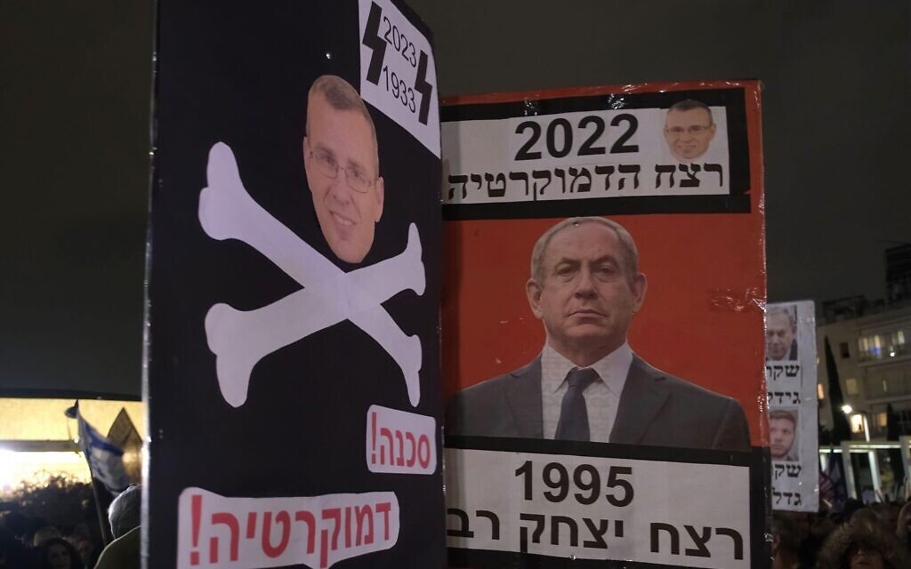 A protester holds up a sign which shows Justice Minister Yariv Levin with crossbones a symbol of Nazi Germany during a demonstration against Israel's new government's judicial system plan that aims to weaken the country's Supreme Court on January 7, 2023, in Tel Aviv, Israel. Civil liberties advocates accuse the new government of declaring war against the legal system, saying the proposed plan will put minority rights in imminent danger and will endanger the country's democracy. Credit: Eddie Gerald/Alamy Live News