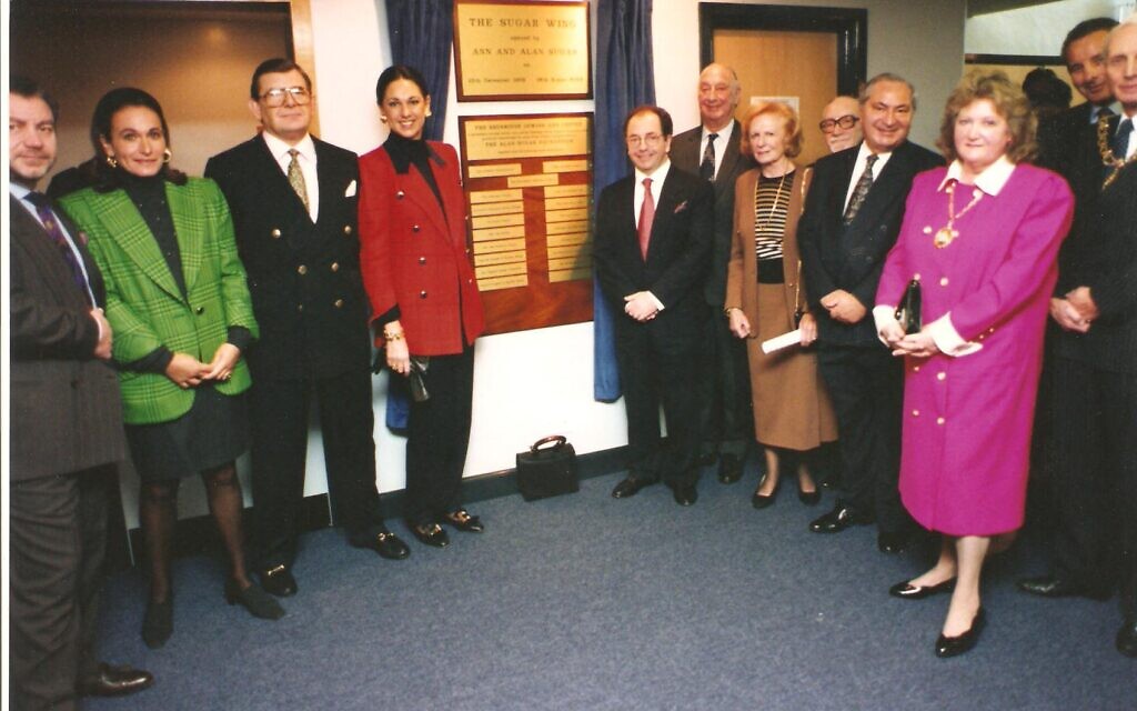 The opening of the Sugar Wing at Sinclair House in 1994. In the image, from left to right is Lord Sugar, Ann Sugar, Gerald Ronson, Dame Gail Ronson, Philip Leigh, Ellis Bik, Lady Birk, Tibor Bolsckei, Frank Cass, and behind the Mayor and Lady Mayoress, Joe Slezinger.