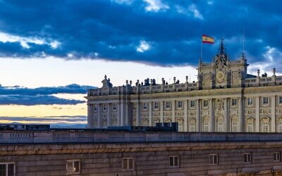 A picture of the Royal Palace of Madrid at sunset.