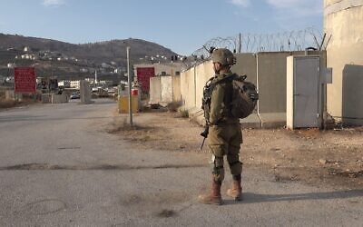 File footage: An Israeli soldier stands in the military Awarta checkpoint one of several checkpoints that surround the Palestinian city of Nablus on October 19, 2022 in the West Bank Israel