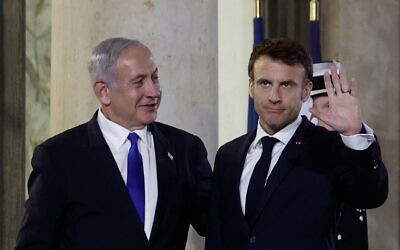 French President Emmanuel Macron welcomes Israeli Prime Minister Benjamin Netanyahu as he arrives for a dinner at the Elysee Palace, in Paris, France, February 2, 2023. REUTERS/Benoit Tessier
