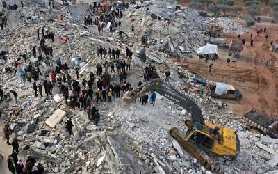 Civil defense workers and residents search through the rubble of collapsed buildings in the town of Harem near the Turkish border, Idlib province, Syria, Monday, Feb. 6, 2023. (AP Photo/Ghaith Alsayed)