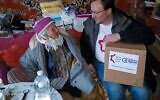 Oleksii Tolkachov (right) from World Jewish Relief's partner organisation - which translates as 'Land of our Dreams' - providing humanitarian aid in the recently liberated city of Kherson