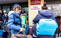 Ukrainians queue at the railway station in Przemysl, Poland, to depart for Ukraine, amid a reversal in migration patterns