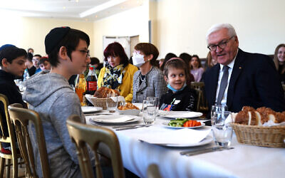 German President Frank-Walter Steinmeier talks with refugee children from the Jewish community in Odessa at a Chabad center in Berlin two days after their arrival as refugees, March 7, 2022. (Clemens Bilan – Pool/Getty Images)