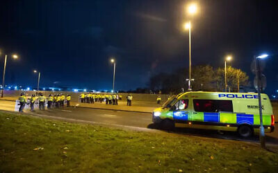 Police in riot gear outside the Suites Hotel in Knowsley, Merseyside (Peter Powell/PA)