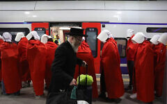An ultra Orthodox Jewish man walks past women wearing costumes from the TV series 'The Handmaid's Tale' during an anti-government protest at a train station in Jerusalem, Israel, 01 March 2023. People have been protesting all over the country against the government’s justice system reform. EPA-EFE/ABIR SULTAN An ultra Orthodox Jewish man walks past women wearing costumes from the TV series 'The Handmaid's Tale' during an anti-government protest at a train station in Jerusalem, Israel, 01 March 2023. People have been protesting all over the country against the government’s justice system reform. EPA-EFE/ABIR SULTAN