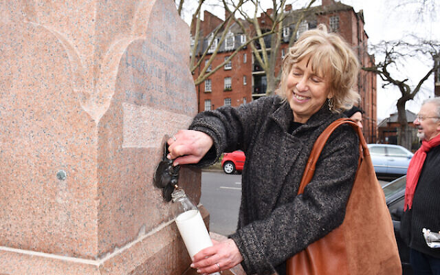 Claire Montefiore, the great-great niece of Leonard Montefiore, takes a drink from the newly restored fountain built in his memory