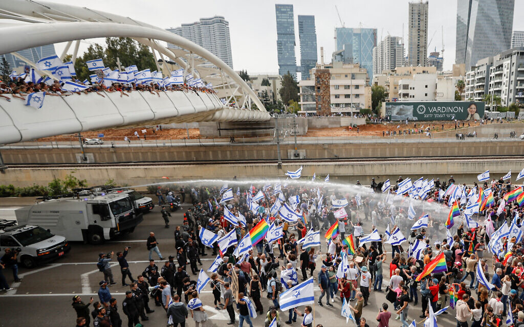 Police use water cannon as demonstrators block a road during the "Day of Shutdown", as Israeli Prime Minister Benjamin Netanyahu's nationalist coalition government presses on with its judicial overhaul, in Tel Aviv, Israel March 23, 2023. REUTERS/Amir Cohen