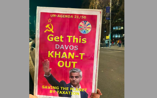 Banner with swastika on right corner featuring Mayor of London Sadiq Khan held by protestor outside event in Ealing