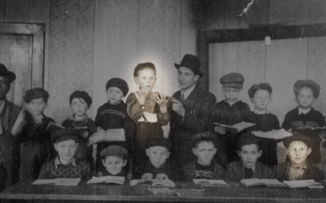 Michael Epstein, highlighted in the bottom row, and Abe Rosenberg, highlighted in the top row, pictured in their classroom in a displaced person's camp in 1947. The two were reconnected by a chance encounter 76 years later. (United States Holocaust Memorial Museum, courtesy of Abraham Rosenberg)