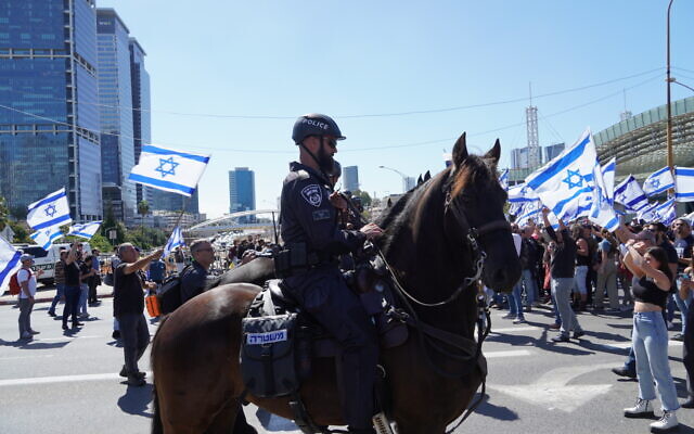 Israeli policemen on horses blocking demonstrators in Tel Aviv from entering the Ayalon Highway. Credit: Jotam Confino