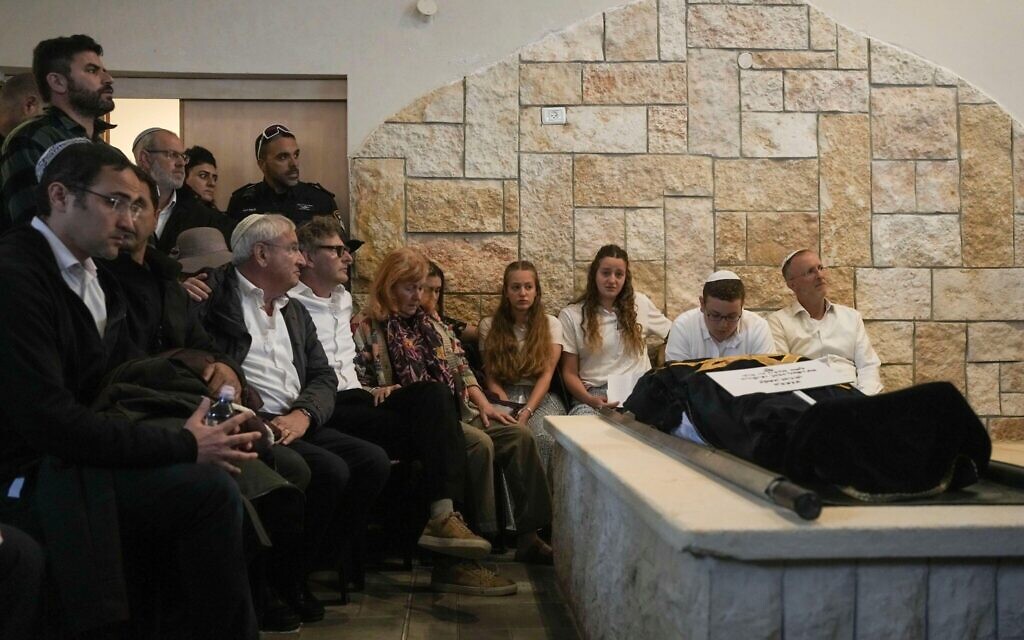 Husband and children of Lucy Dee mourn during her funeral at a cemetery in the West Bank settlement of Kfar Etzion, Tuesday, April 11, 2023. The British-Israeli woman died of wounds suffered in an April 7 shooting by Palestinian gunmen in the West Bank that also killed her daughters, Maia and Rina Dee. (AP Photo/Maya Alleruzzo)