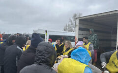 Marie van der Zyl, centre, helps with a food distribution to migrants  inside the Dunkirk camp