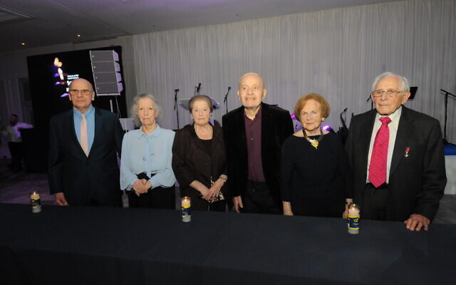 45 AID 2023 Dinner survivors (pictured left to right) Jackie Young, Zdenka Husserl, Rachel Levy, Victor Greenberg, Mala Tribich and Harry Olmer, lit 6 memorial candles to represent the 6 million Jewish lives tragically lost during the Holocaust. 
Photo John Rifkin