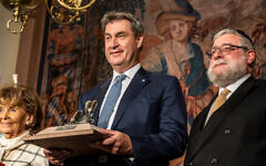 Bavaria’s Minister-President Markus Söder, center, receives an award from the Conference of European Rabbis in Munich, May 9, 2023. On right is CER President Pinchas Goldschmidt and on left is Charlotte Knobloch, head of the Jewish Community of Munich and upper Bavaria. (Marc Müller/CER) Bavaria’s Minister-President Markus Söder, center, receives an award from the Conference of European Rabbis in Munich, May 9, 2023. On right is CER President Pinchas Goldschmidt and on left is Charlotte Knobloch, head of the Jewish Community of Munich and upper Bavaria. (Marc Müller/CER)