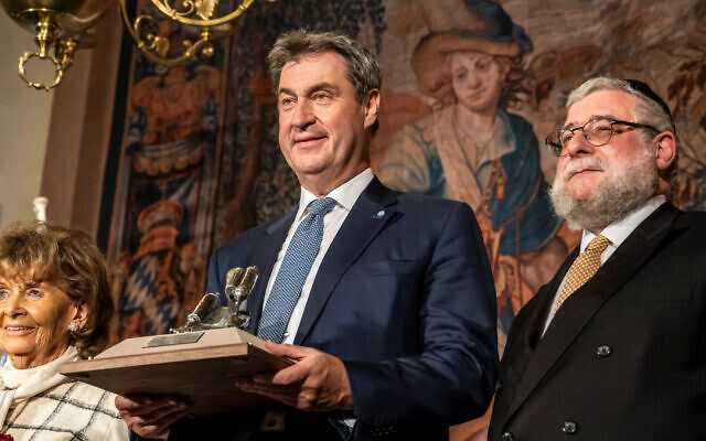 Bavaria’s Minister-President Markus Söder, center, receives an award from the Conference of European Rabbis in Munich, May 9, 2023. On right is CER President Pinchas Goldschmidt and on left is Charlotte Knobloch, head of the Jewish Community of Munich and upper Bavaria. (Marc Müller/CER)