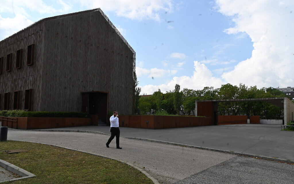 Rabbi Slomo Koves walks across the parking area of the House of Fates Holocaust museum in Budapest, Hungary on Aug. 27, 2021. (Cnaan Liphshiz)