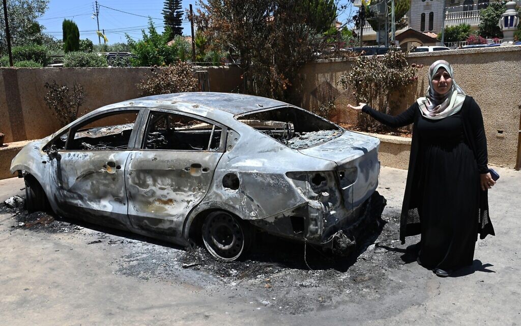 Palestinian-American Ameena Abu Awad from Chicago stands near a car was torched by Israeli settlers in Turmus Ayya, West Bank, on Friday, June 23, 2023. Hundreds of masked and armed Israeli settlers rampaged the peaceful village of Turmus Ayya on Wednesday, where they burned cars and homes of Palestinians in a revenge attack after four Israelis were shot by Palestinian gunmen. Photo by Debbie Hill/ Credit: UPI/Alamy Live News