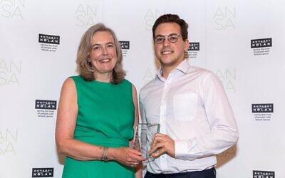 Max Blum (r), Sue Harris Trust Volunteer, receives the award from Henny Braund MBE