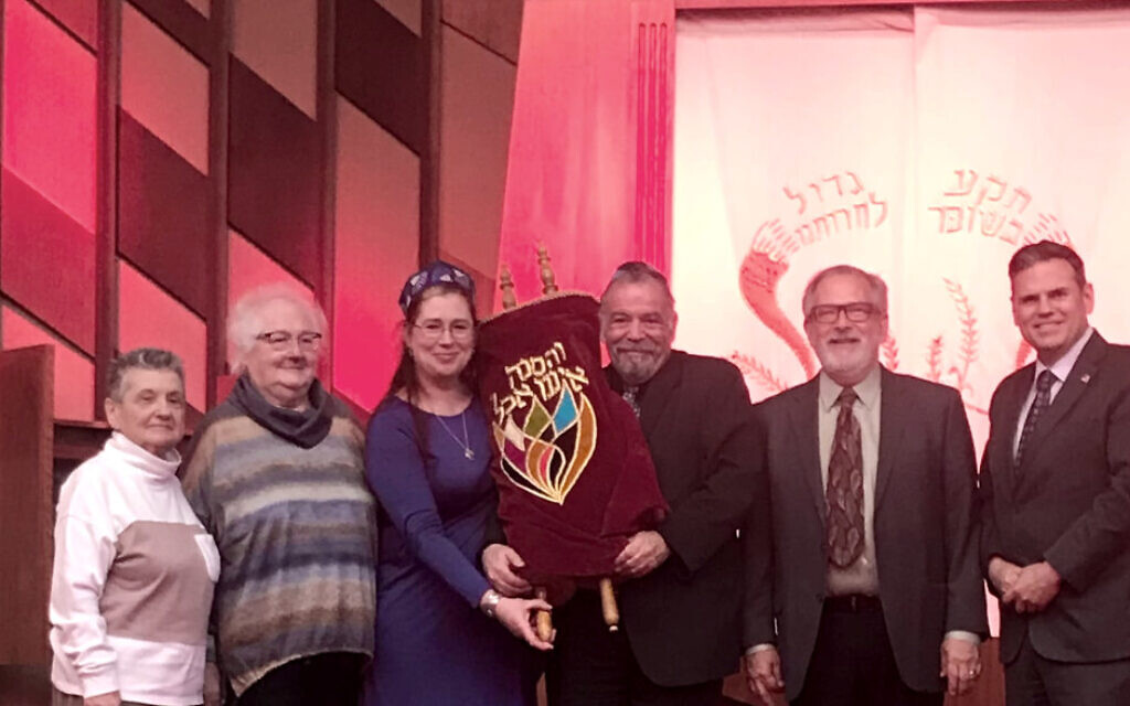 Cork Jewish Community Secretary Sophia Spiegel receiving the Torah during her visit to Massachusetts. Pic: Cork Jewish community