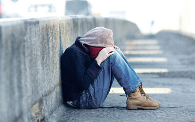 Stock imagery: young homeless boy sleeping on the bridge.