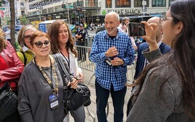 Anti-government protesters are filmed by UnXeptable activist Shany Granot-Lubaton after being ejected from the Jerusalem Post conference in New York City, June 5, 2023. (Ben Sales)