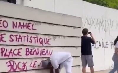 Vandals daub a Holocaust memorial with anti-police slogans during riots in Paris during July 2023
