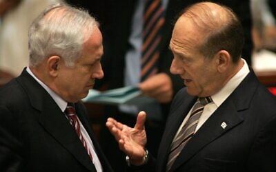 Ehud Olmert, right, confers with Prime Minister Benjamin Netanyahu during a session at the Knesset.