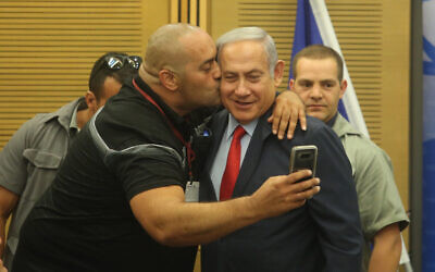 Prime Minister Benjamin Netanyahu poses for a selfie with Itzik Zarka, a Likud activist and fan, during a Likud party faction meeting at the Knesset.
(photo credit: MARC ISRAEL SELLEM)