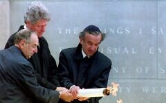 U.S. President Bill Clinton, center, lights the eternal flame at the dedication of the United States Holocaust Memorial Museum with help from Memorial Council chairman Harvey Meyerhoff, left, and founding chairman Elie Wiesel, April 22, 1993. (Renaud Giroux/AFP via Getty Images) U.S. President Bill Clinton, center, lights the eternal flame at the dedication of the United States Holocaust Memorial Museum with help from Memorial Council chairman Harvey Meyerhoff, left, and founding chairman Elie Wiesel, April 22, 1993. (Renaud Giroux/AFP via Getty Images)